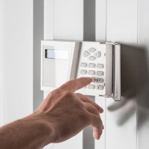 A hand setting a home security keypad