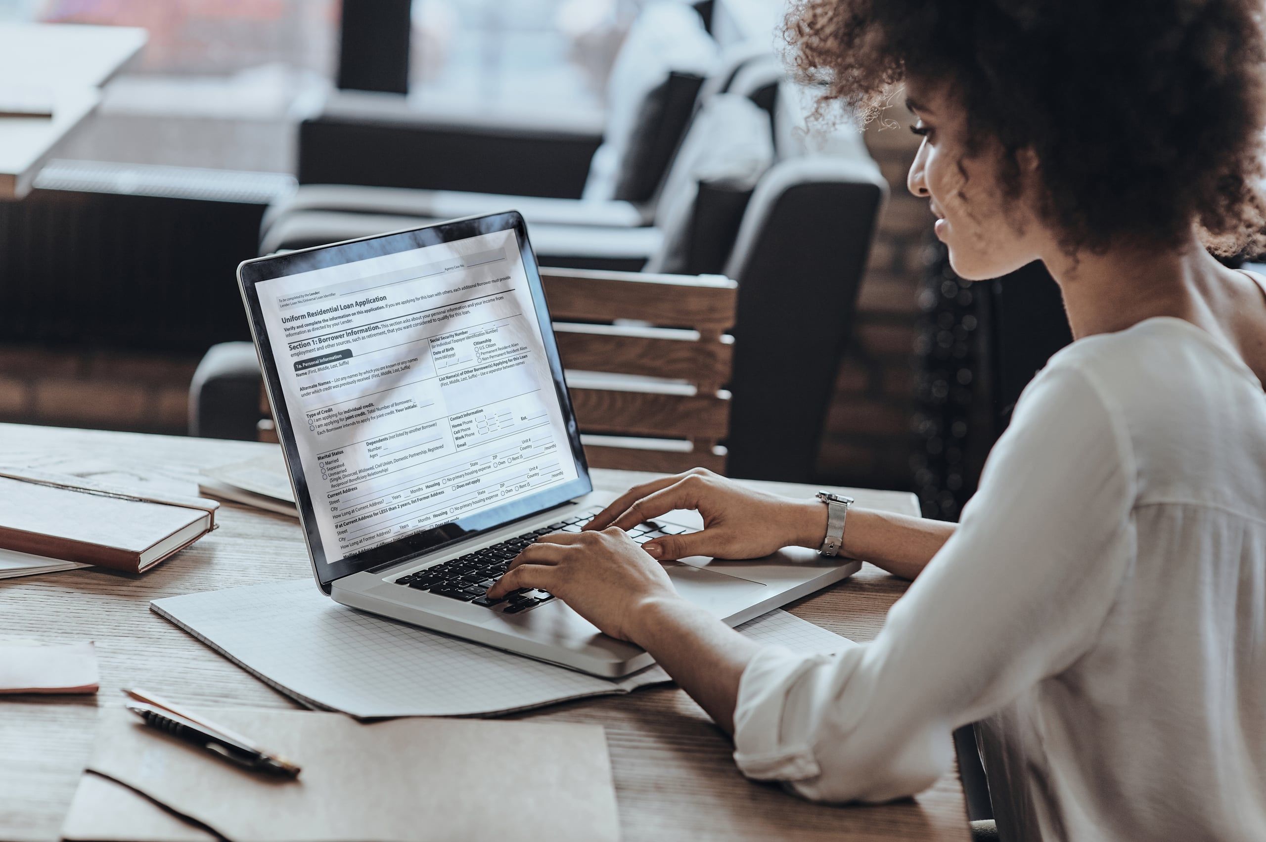 A homebuyer filling out a mortgage application on a laptop